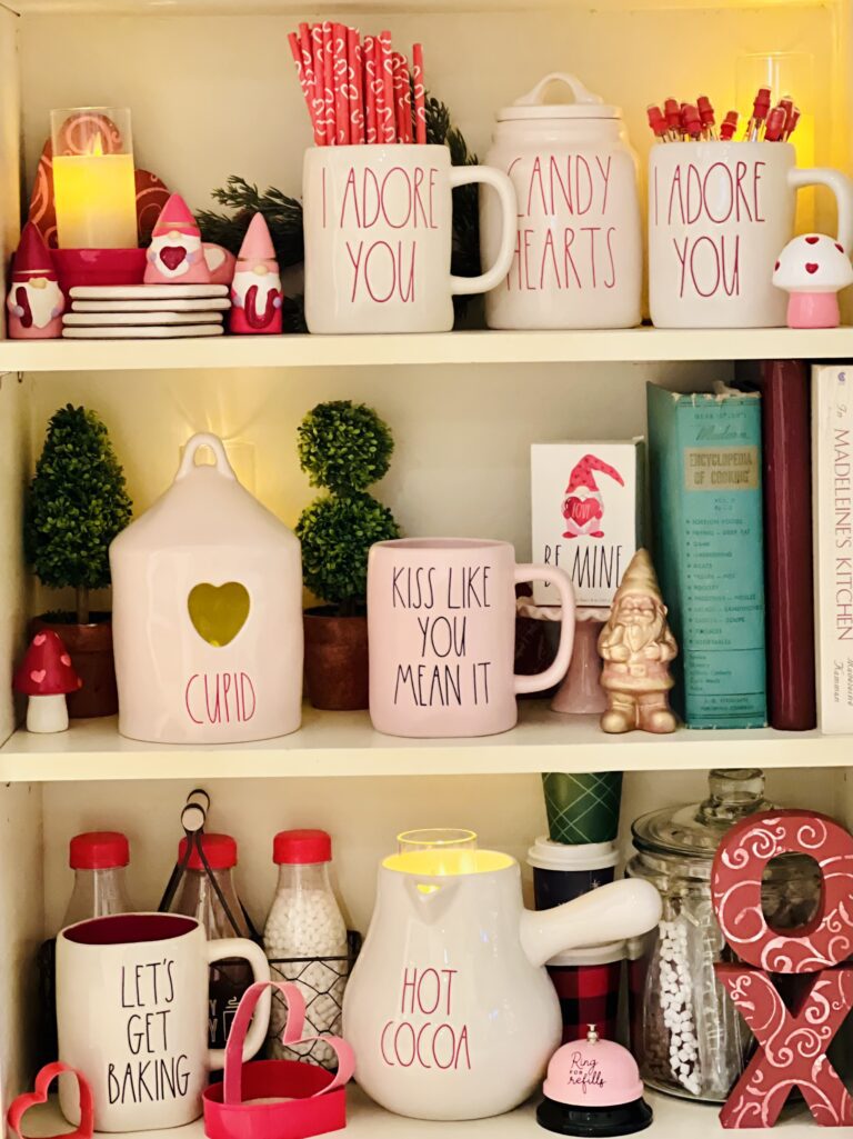 Kitchen bookshelf décor Rae Dunn mugs cupid bird house topiary trees gilded gold ceramic gnomes DIY crafts Valentine's day Target dollar Spot vintage cook books
