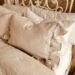 Linen bedding with ruffle edge natural neutral color French country bedroom makeover gel pillows Sleep Number bed wrought iron headboard painted white with chalk paint and all in one paint