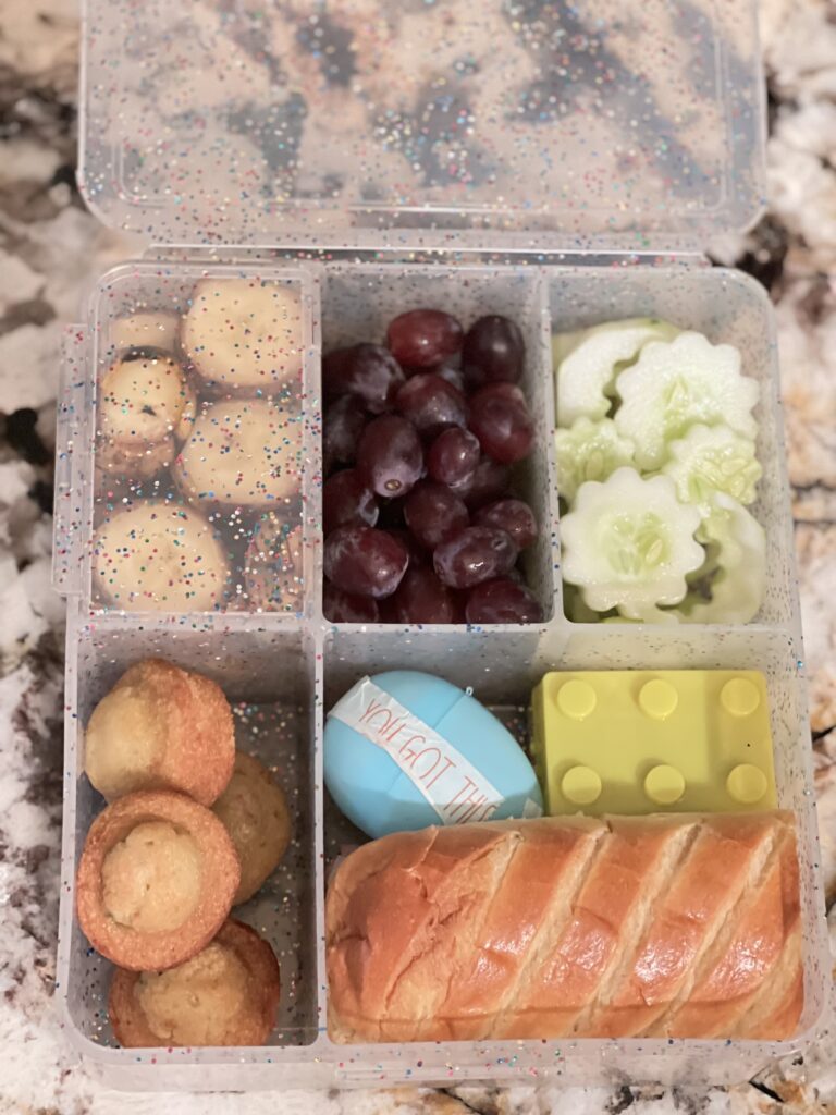 Cucumber flower shape cutouts in small leak proof plastic container for Bento Box lunch