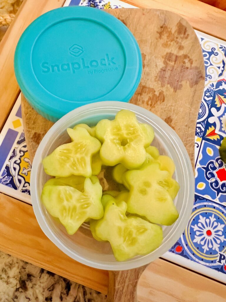 Cucumber flower shape cutouts in small leak proof plastic container for Bento Box lunch