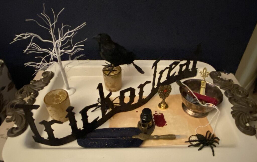 trick or treat Halloween sign on GG collection tray with crows spiders haunted mansion