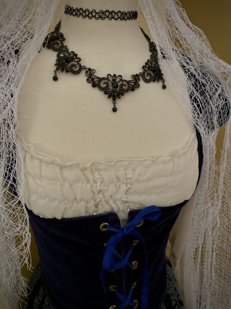 Halloween dress form with renaissance costume gauze draped black vampire necklace