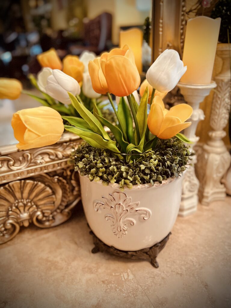 tulips in gg collection acanthus planter in front of mirror topiary wreath candlesticks